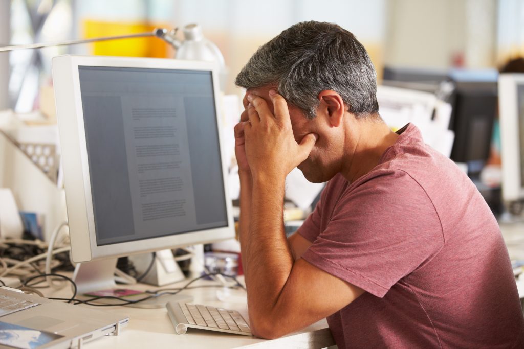 stressed man working at desk